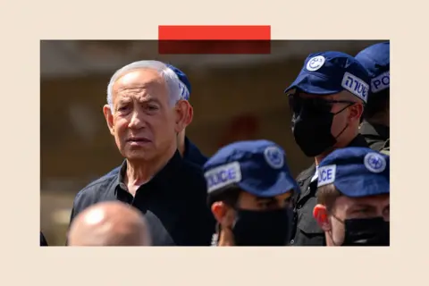 Getty Images Benjamin Netanyahu reacts while visiting the area destroyed by an Iranian ballistic missile