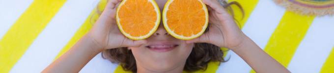 banner showing child holding oranges