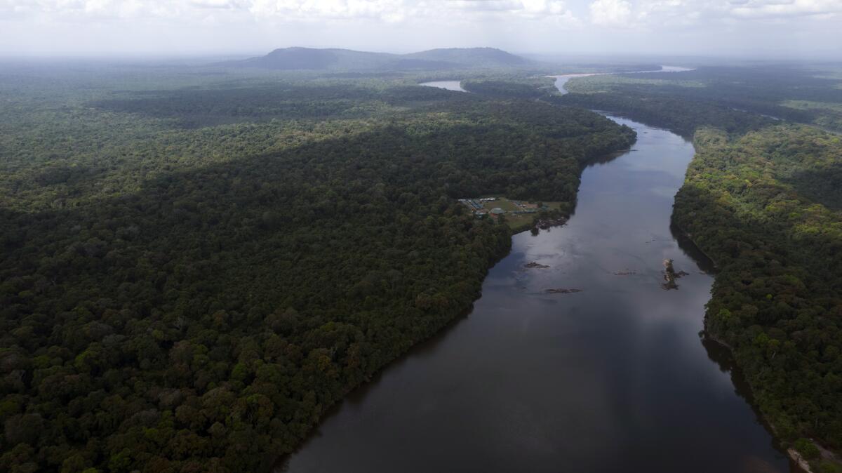 The Essequibo River flows through Kurupukari crossing in Guyana, Saturday, Nov. 19, 2023. Venezuela has long claimed Guyanas Essequibo region, a territory larger than Greece and rich in oil and minerals. (AP Photo/Juan Pablo Arraez)